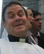 Brian Leslie in the role of Fr. Mark