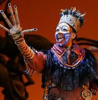 Phindile Mkhize as Rafiki in the opening number The Circle of Life from THE LION KING National Tour.  Disney.  Photo Credit:  Joan Marcus.